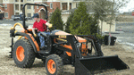 Compact utility tractor powers various attachments over challenging terrain