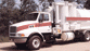 Truck-mounted loader vacuums sludge or slurry