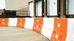 Water-ballasted barrier provides impact-absorbing traffic control