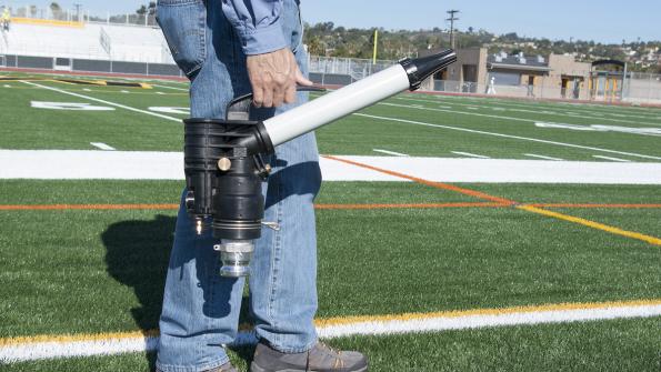 Turf tool cools and cleans synthetic sports fields